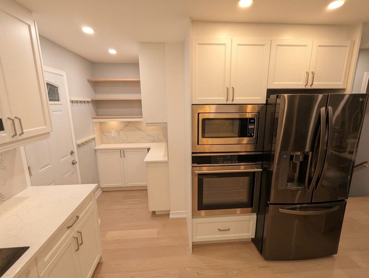 Kitchen with Aline Shaker White cabinets and built-in ovens